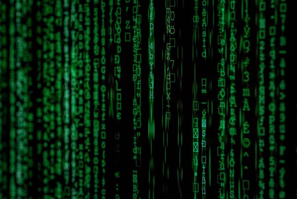 Artistic image of code strings running across a black background.