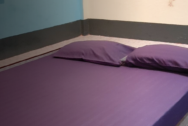 Real image of a bed in a room where a survivor was being trafficked in Thailand.
